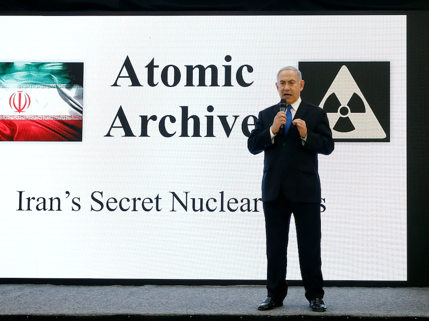 رئيس الوزراء الإسرائيلي السابق بنيامين نتنياهو يستعرض وثائق من "الأرشيف النووي" الإيراني خلال مؤتمر صحافي بتل أبيب. 30 أبريل 2018 - REUTERS