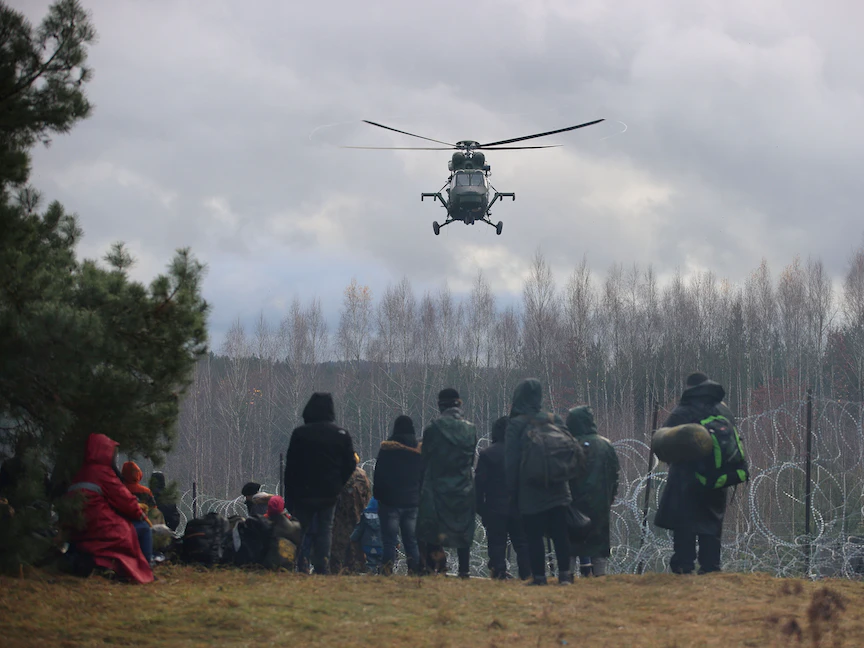 مهاجرون يتجمعون بالقرب من سياج الأسلاك الشائكة في محاولة لعبور الحدود إلى بولندا من منطقة جرودنو في بيلاروسيا - 8 نوفمبر 2021 - REUTERS