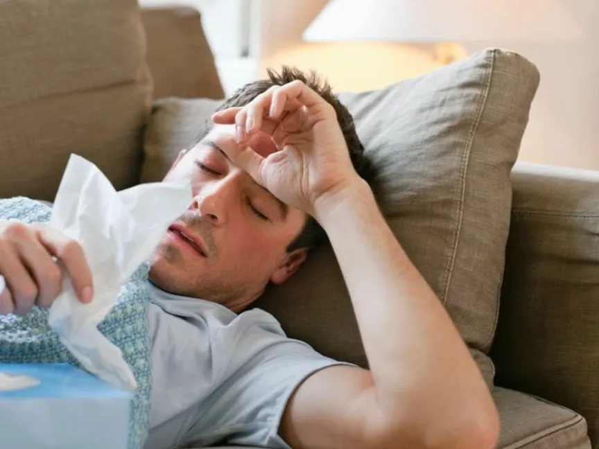 رجل يعاني من أعراض الإرهاق والحمى - Getty Images