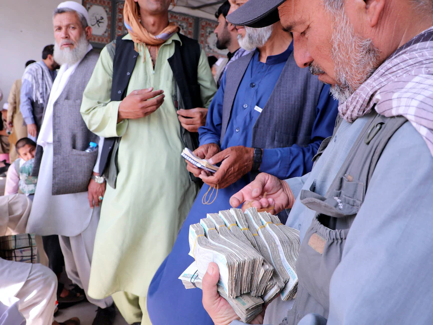 تجار الصرافة في أفغانستان ينتظرون العملاء عقب إعادة فتح البنوك والأسواق الأفغانية، 4 سبتمبر 2021. - REUTERS