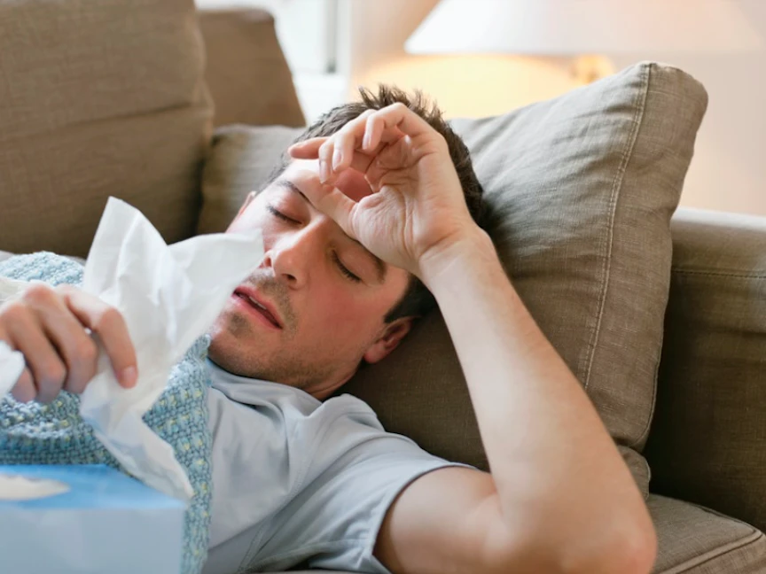 رجل يعاني من أعراض الإرهاق والحمى. - Getty Images