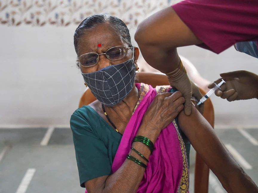 هندية تتلقى جرعة من لقاح "أسترازينيكا" المضاد لكورونا في مركز للتطعيم بأحد أحياء مومباي. 29 يونيو 2021 - AFP