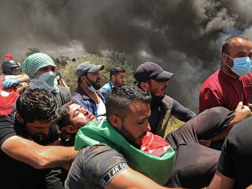 متظاهرون فلسطينيون يحملون مصاباً خلال مواجهات مع قوات الأمن الإسرائيلية في جبل صبيح ببلدة بيتا جنوب نابلس - 4 يونيو 2021 - AFP