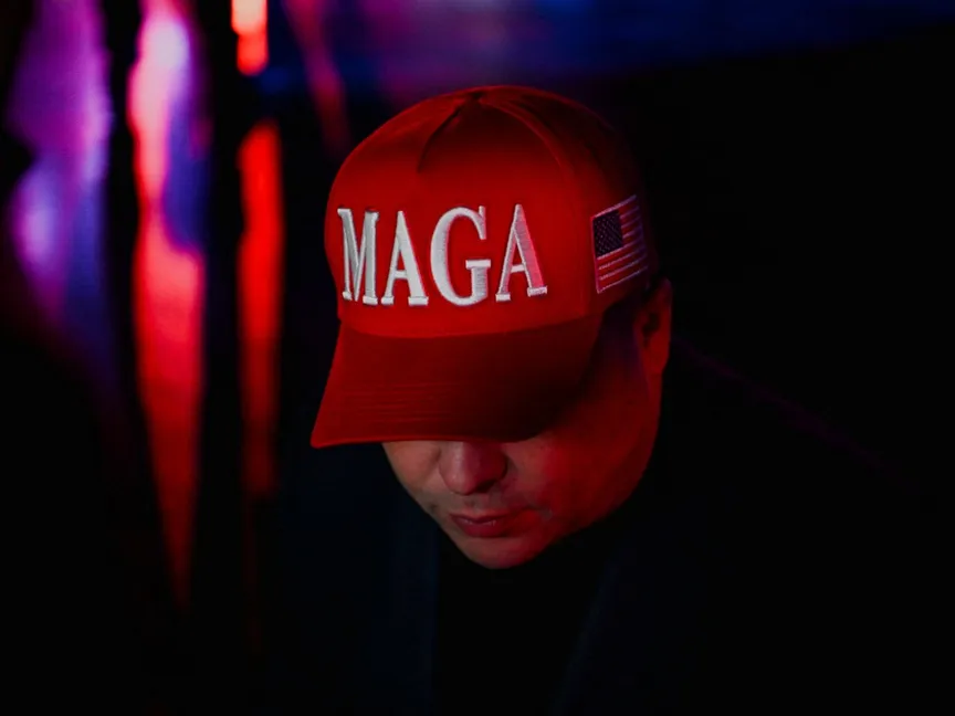 أحد أنصار الرئيس الأميركي دونالد ترمب يرتدي قبعة MAGA (لنجعل أميركا عظيمة مرة أخرى) في فلوريدا. 5 نوفمبر 2024 - Reuters