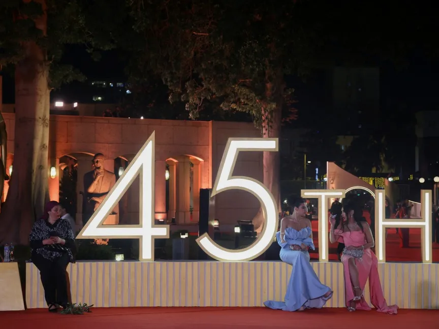 ممثلون مصريون يجلسون على لافتة، على السجادة الحمراء خلال مهرجان القاهرة السينمائي الدولي الخامس والأربعين CIFF في دار الأوبرا بالقاهرة، مصر. 13 نوفمبر 2024 - Reuters