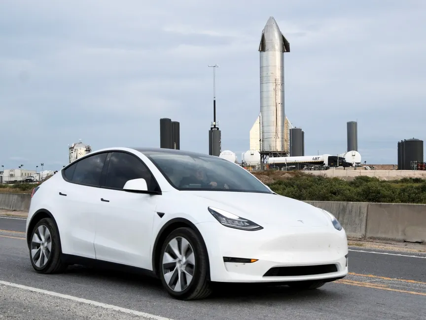 رجل يقود سيارة تسلا بينما تظهر مركبة فضاء تابعة لشركة سبيس إكس في الخلف بولاية تكساس الأميركية. 4 ديسمبر 2020 - Reuters