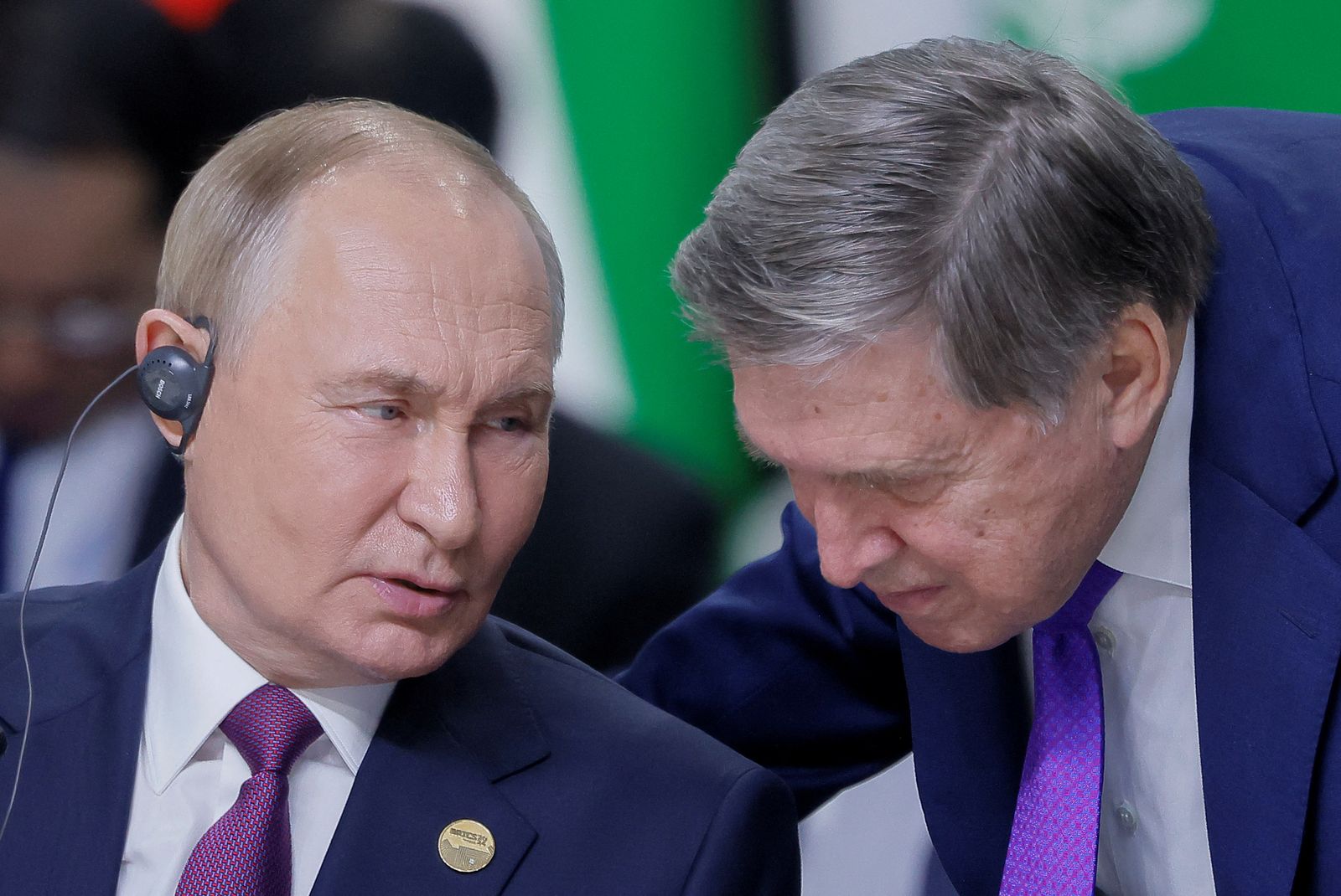 Russian President Vladimir Putin speaks with his aide Yuri Ushakov during a plenary session in the outreach/BRICS Plus format at the BRICS summit in Kazan, Russia October 24, 2024. REUTERS/Maxim Shemetov/Pool