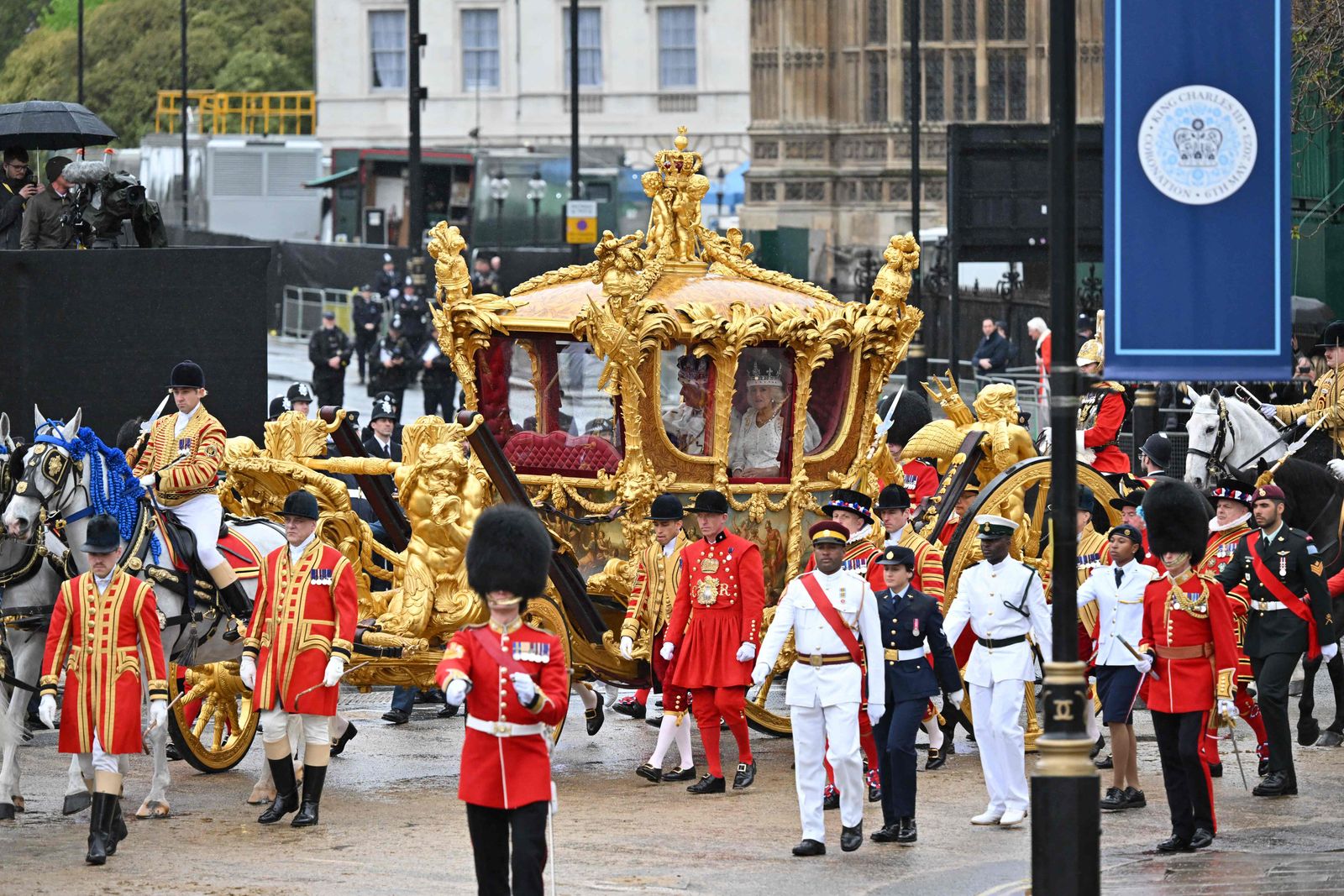 Britain's Queen Camilla and Britain's King Charles III travel in the Gold State Coach, back to Buckingham Palace from Westminster Abbey in central London on May 6, 2023, after their coronations. - The set-piece coronation is the first in Britain in 70 years, and only the second in history to be televised. Charles will be the 40th reigning monarch to be crowned at the central London church since King William I in 1066. Outside the UK, he is also king of 14 other Commonwealth countries, including Australia, Canada and New Zealand. Camilla, his second wife, was crowned alongside him, and will now be known as Queen Camilla. (Photo by Glyn KIRK / AFP) - AFP