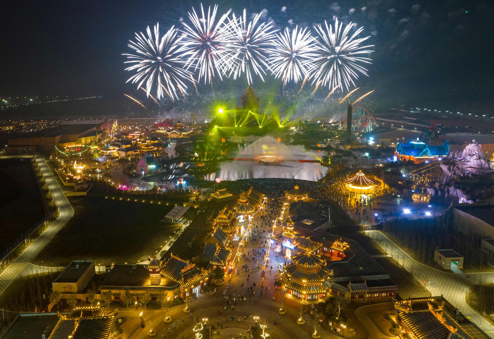 This aerial photo taken on December 31, 2022, shows fireworks lighting up the sky over the Xiyou World theme park ahead of the new year in Huaian, in China's eastern Jiangsu province. (Photo by AFP) / China OUT - AFP