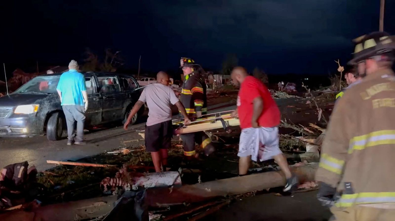A rescue worker and people carry a stretcher in the aftermath of a tornado, in London, Kentucky, U.S., in this still image obtained from a video released on May 17, 2025. LAUREL COUNTY, KY. FISCAL COURT/Handout via REUTERS    THIS IMAGE HAS BEEN SUPPLIED BY A THIRD PARTY. MANDATORY CREDIT. NO RESALES. NO ARCHIVES.
