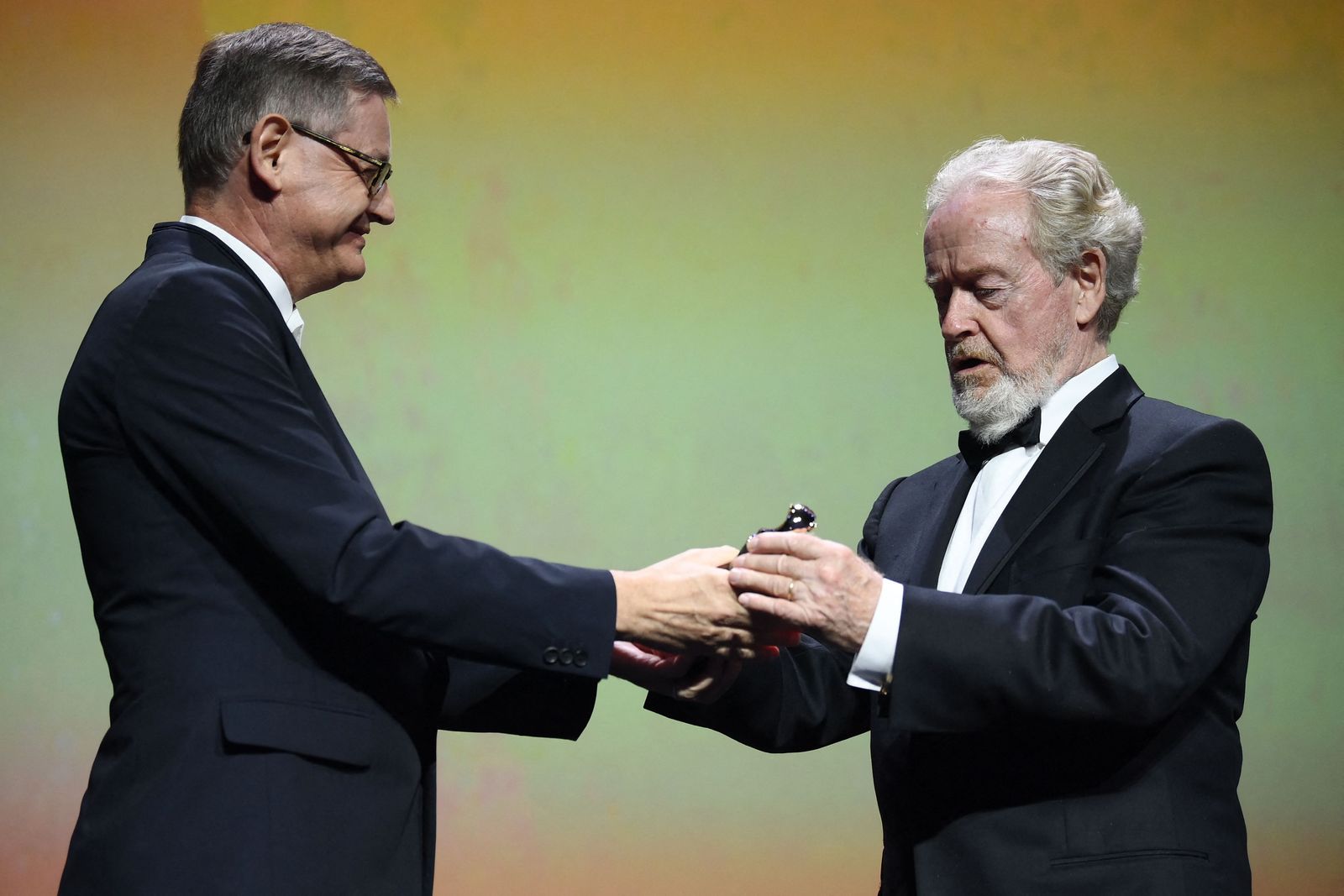 Cartier CEO Cyrille Vigneron hands to US director Ridley Scott the Cartier Glory To The Filmmaker Award on September 10, 2021 at the 78th Venice Film Festival in Venice Lido. (Photo by Marco BERTORELLO / AFP) - AFP