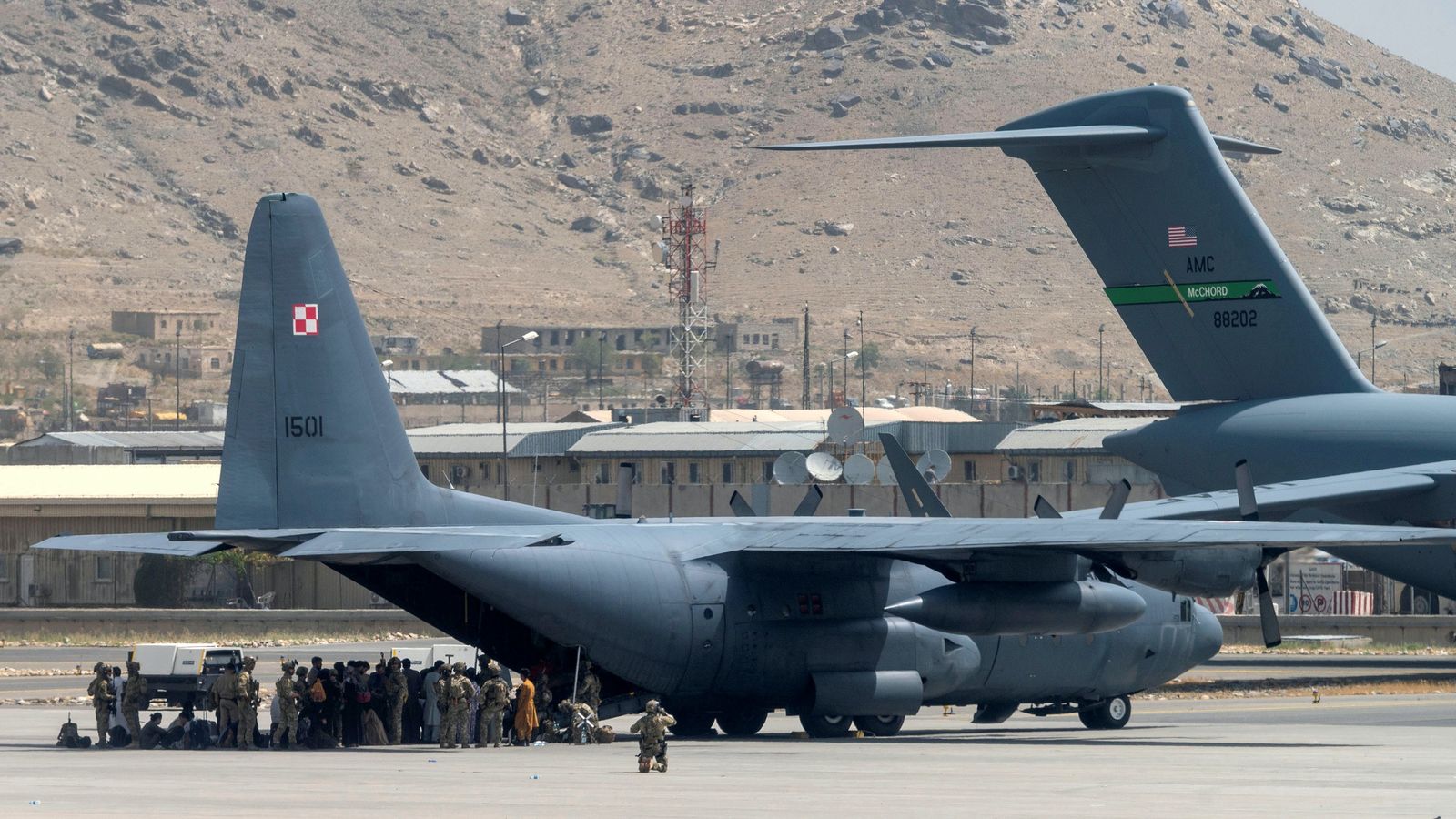 أفراد من خدمة وزارة الدفاع الأمريكية، يراقبون الطائرات في مطار حامد كرزاي الدولي في كابول أفغانستان- 17 أغسطس 2021 - via REUTERS