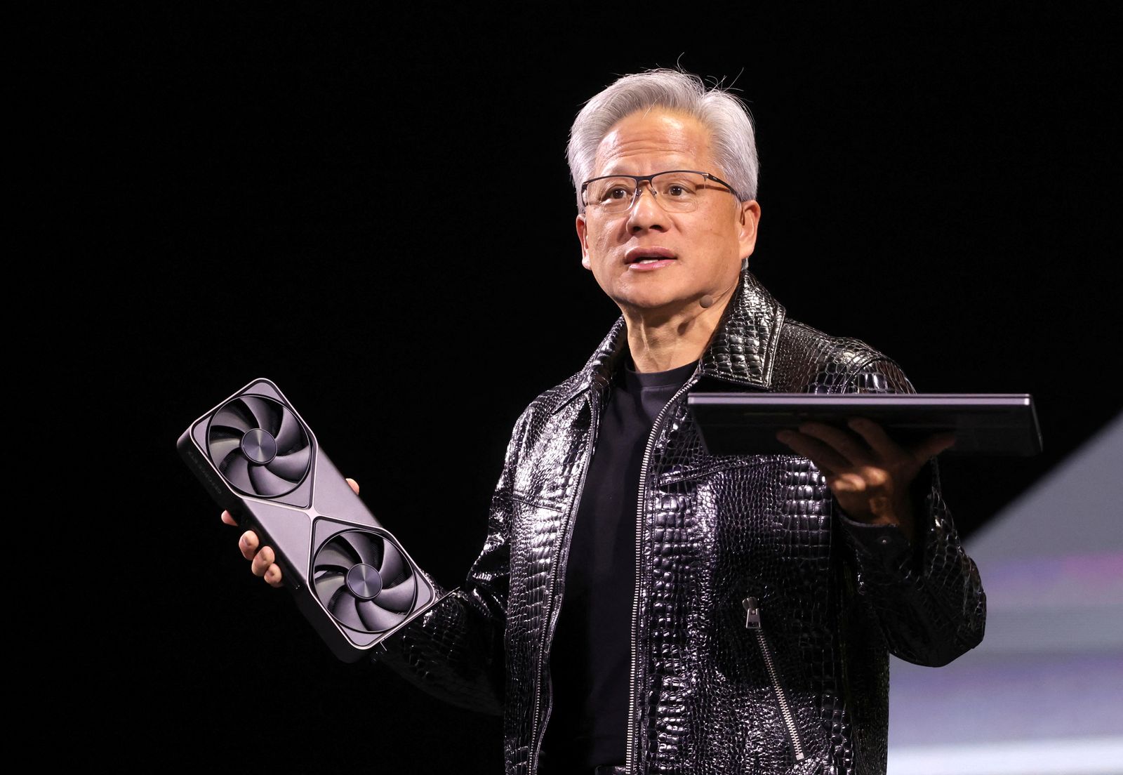 Nvidia CEO Jensen Huang holds a new Nvidia GeForce RTX 5090 graphics card and an RTX 5070 laptop as he gives a keynote address at CES 2025, an annual consumer electronics trade show, in Las Vegas, Nevada, U.S. January 6, 2025.  REUTERS/Steve Marcus