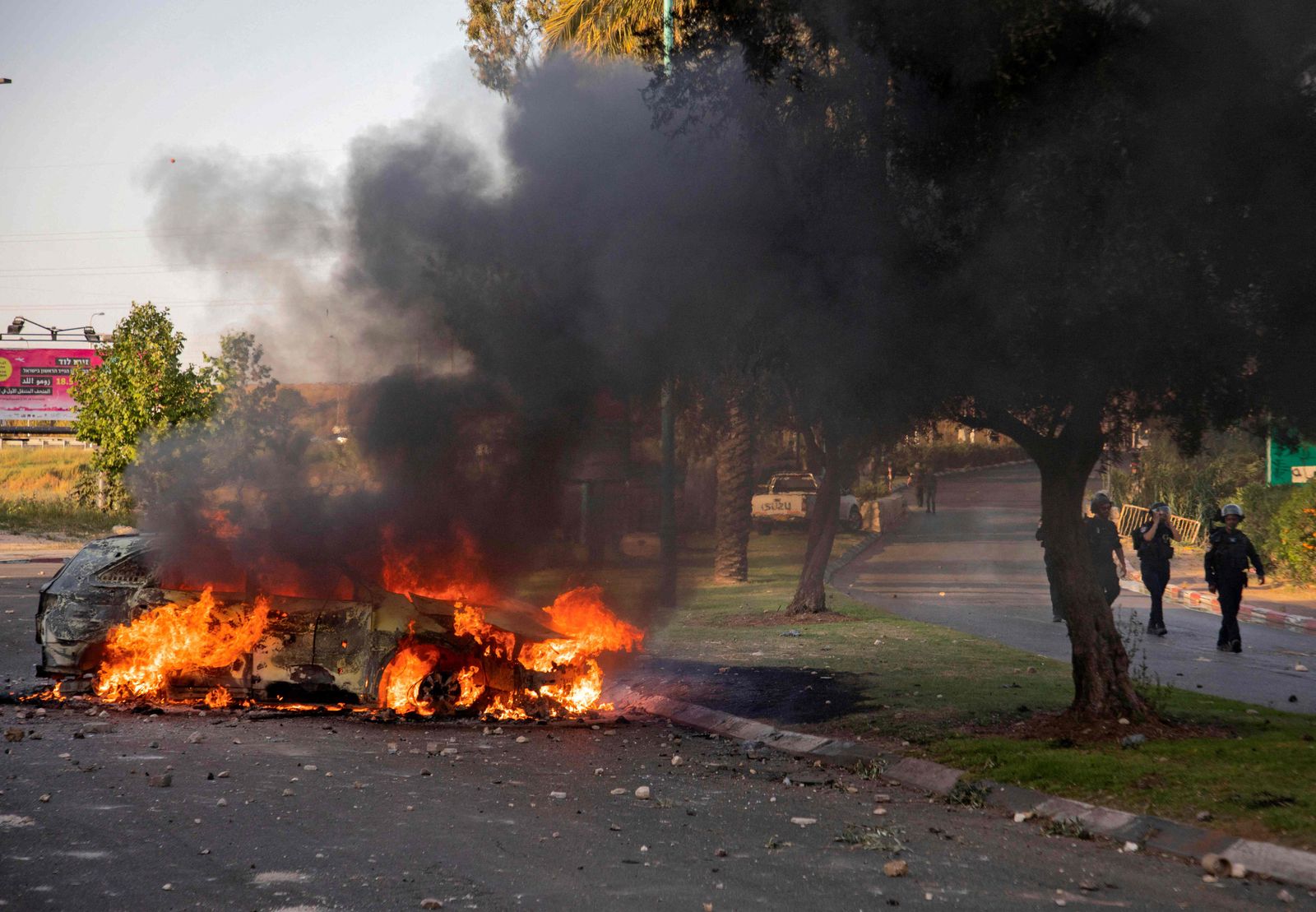 An Israeli police car burns after an Arab Israeli demonstration following the funeral of Mousa Hassouna in the central city of Lod near Tel Aviv, on May 11, 2021. - Hassouna was killed during clashes with Israeli security following an anti-Israel demonstration over tensions in Jerusalem. (Photo by - / AFP) - AFP