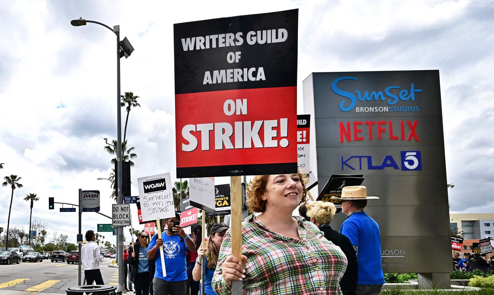 Writer Leila Cohan holds her sign on the picket line on the fourth day of the strike by the Writers Guild of America in front of Netflix in Hollywood, California on May 5, 2023. - The Hollywood writers' strike broke out this week over pay, but the refusal of studios like Netflix and Disney to rule out artificial intelligence replacing human scribes in the future has only fueled anger and fear on the picket lines. With their rapidly advancing ability to eerily mimic human conversation, AI programs like ChatGPT have spooked many industries recently. The White House this week summoned Big Tech to discuss the potential risks. (Photo by Frederic J. BROWN / AFP) - AFP