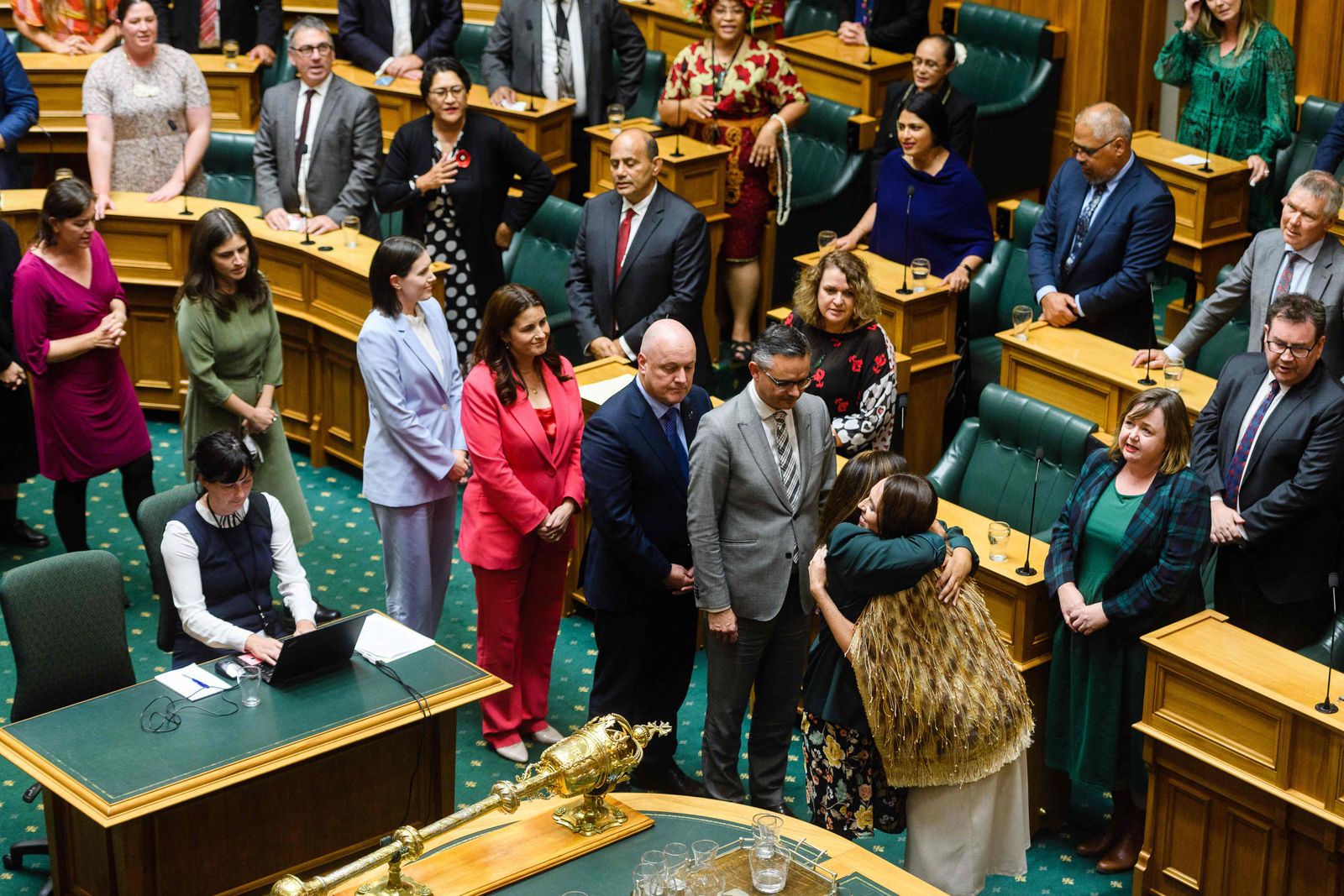 Outgoing New Zealand prime minister Jacinda Ardern hugs members of parliament after giving her valedictory speech in parliament in Wellington on April 5, 2023. (Photo by Mark Coote / AFP) - AFP