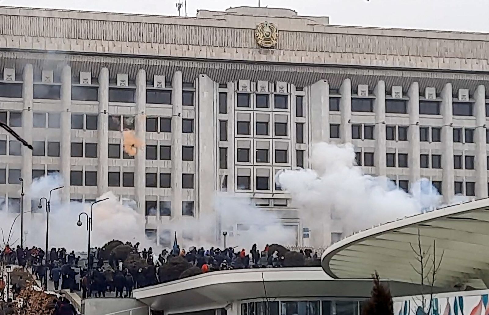 This image grab shows protesters near an administrative building during a rally over a hike in energy prices in Almaty on January 5, 2022. - Protesters stormed the mayor's office in Kazakhstan's largest city Almaty on January 5, 2022 as unprecedented unrest in the Central Asian nation spun out of control. (Photo by AFP) - AFP