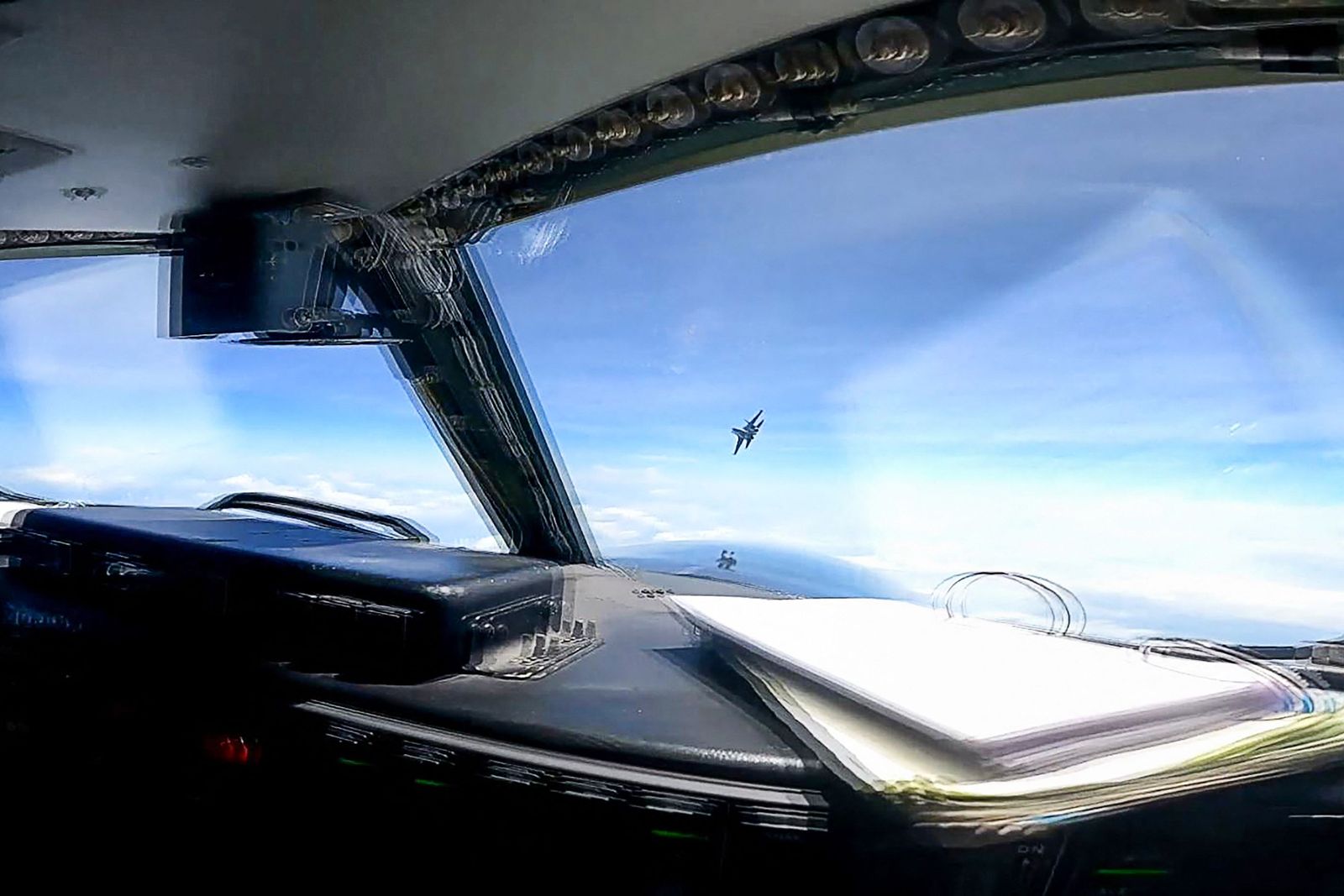 This screen grab made from video taken on May 26, 2023 and released on May 30 by the US Indo-Pacific Command via the Defense Visual Information Distribution Service (DVIDS) shows a J-16 fighter pilot from China flying in front of the nose of a US Air Force RC-135 aircraft over the South China Sea in international airspace. (Photo by Handout / DVIDS / AFP) / -----EDITORS NOTE --- RESTRICTED TO EDITORIAL USE - MANDATORY CREDIT 