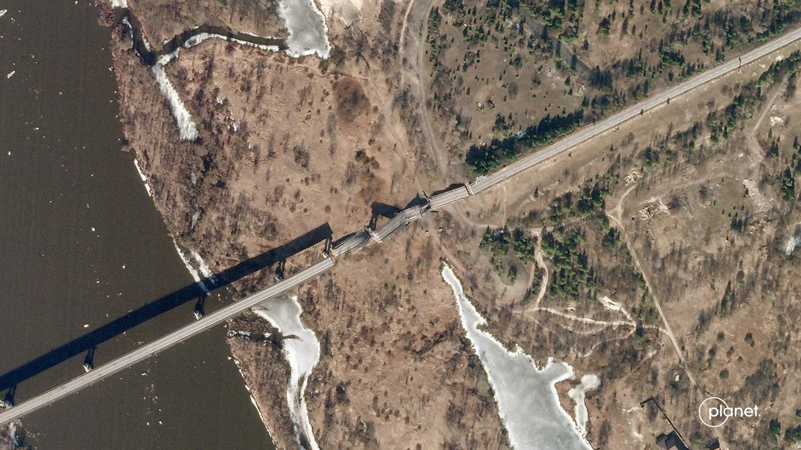 This satellite image released by Planet Labs PBC, shows the Kamaryn Slavutych Border Crossing Bridge over the Dnieper River between Ukraine and Belarus on February 26, 2022, after it was reportedly blown up by Ukrainian forces. - Russia on February 26, 2022, ordered its troops to advance in Ukraine 