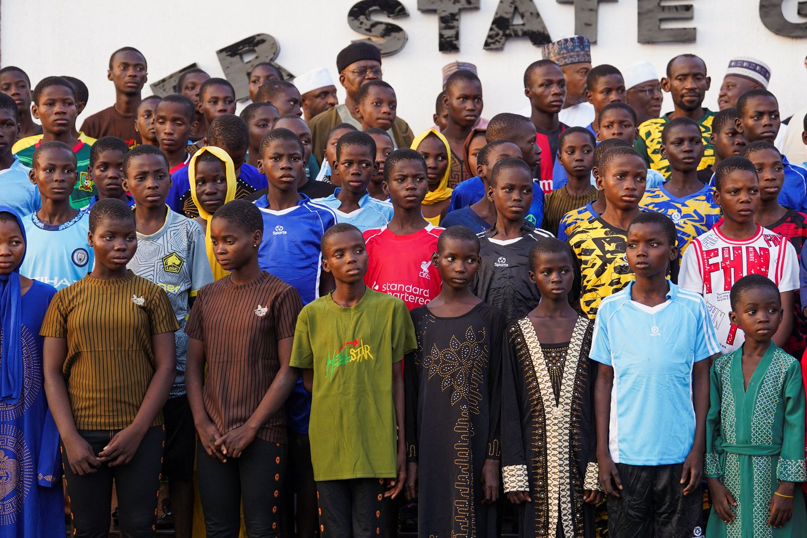Schoolchildren abducted from St. Mary’s School pose for a photograph after arriving at the Niger State Government House following their rescue, in Minna, Nigeria, December 8, 2025. REUTERS/Marvellous Durowaiye