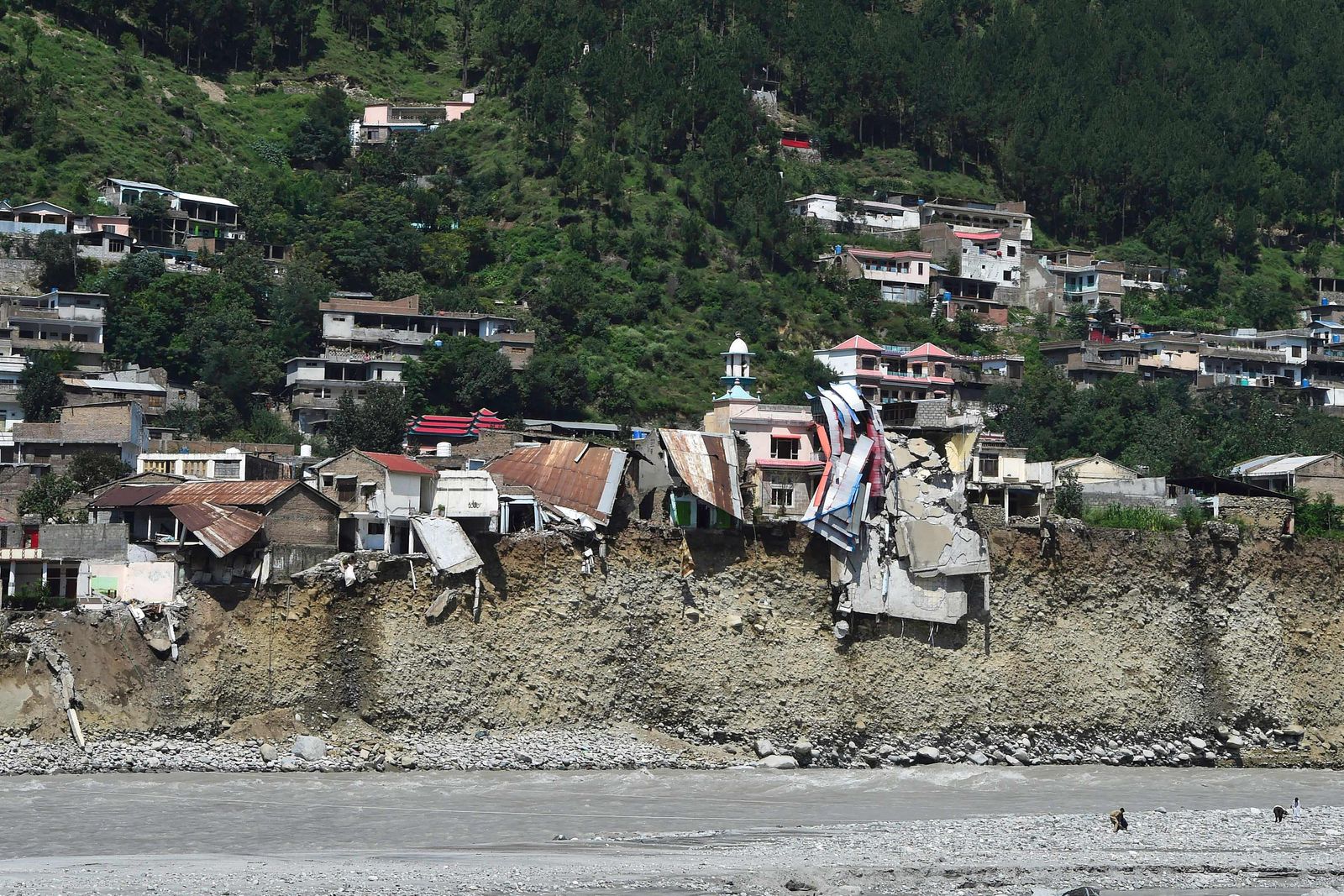 A general view shows houses destroyed by flash floods near the banks of the Swat River after heavy rains in Madyan area of Swat valley, Khyber Pakhtunkhwa province, on August 31, 2022. - Aid efforts ramped up across flooded Pakistan on August 30 to help tens of millions of people affected by relentless monsoon rains that have submerged a third of the country and claimed more than 1,100 lives. (Photo by Abdul MAJEED / AFP) - AFP