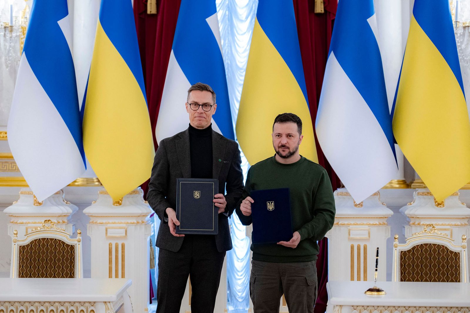 This handout photograph taken and released by the Ukrainian Presidential press service in Kyiv on April 3, 2024, shows Ukrainian President Volodymyr Zelensky (R) and President of Finland Alexander Stubb (L) holding signed bilateral documents during their meeting in Kyiv, amid the Russian invasion in Ukraine. (Photo by HANDOUT / UKRAINIAN PRESIDENTIAL PRESS SERVICE / AFP) / RESTRICTED TO EDITORIAL USE - MANDATORY CREDIT 'AFP PHOTO / HO / UKRAINIAN PRESIDENTIAL PRESS SERVICE ' - NO MARKETING NO ADVERTISING CAMPAIGNS - DISTRIBUTED AS A SERVICE TO CLIENTS