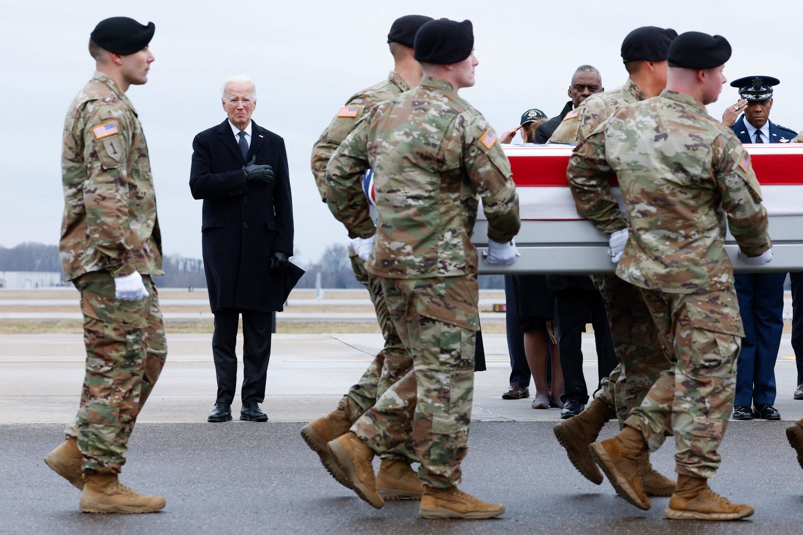 DOVER, DELAWARE - FEBRUARY 02: U.S. President Joe Biden places his hand over his heart while watching a U.S. Army carry team move a flagged draped transfer case containing the remains of Army Sgt. William Rivers during a dignified transfer at Dover Air Force Base on February 02, 2024 in Dover, Delaware. U.S. Army Sgt. William Rivers, Sgt. Breonna Moffett, and Sgt. Kennedy Sanders was killed in addition to 40 other troops who were injured during a drone strike in Jordan.   Kevin Dietsch/Getty Images/AFP (Photo by Kevin Dietsch / GETTY IMAGES NORTH AMERICA / Getty Images via AFP)