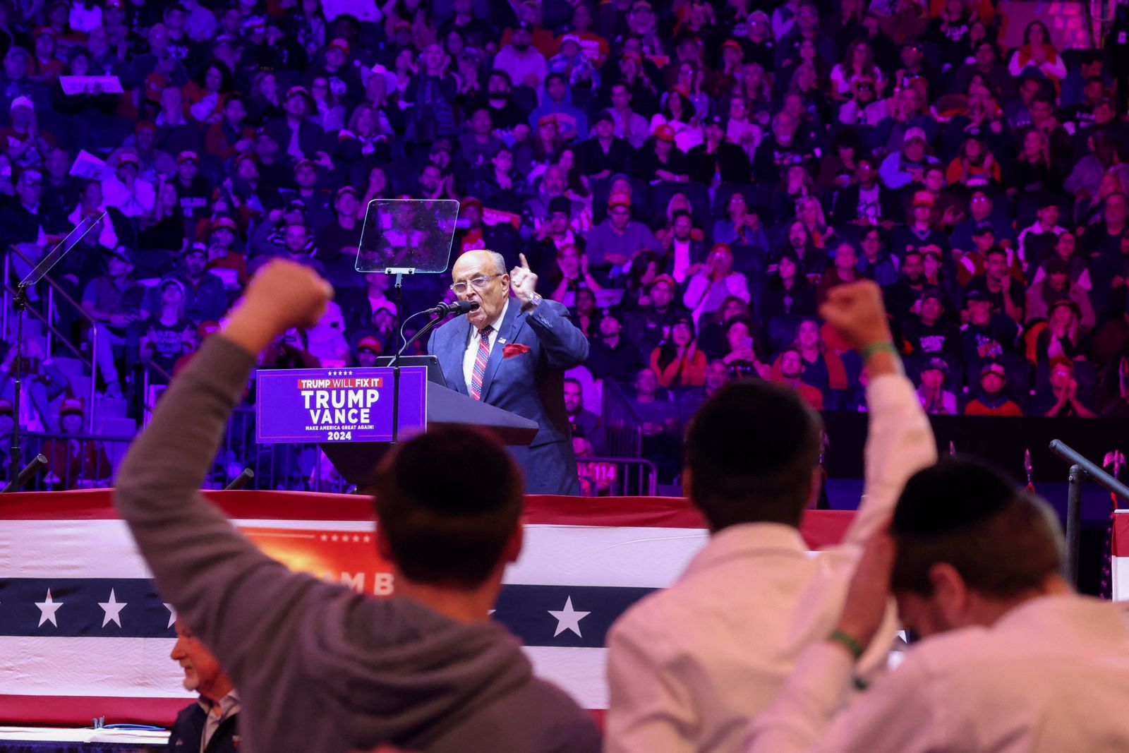 Supporters wearing kippa gesture as former mayor of New York City and former Trump lawyer Rudy Giuliani speaks during a rally for Republican presidential nominee and former U.S. President Donald Trump at Madison Square Garden, in New York, U.S., October 27, 2024. REUTERS/Brendan McDermid