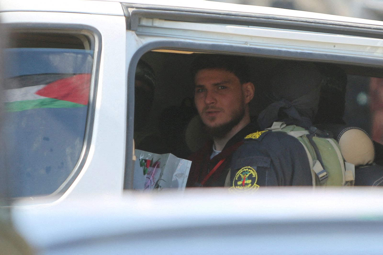 Russian-Israeli Sasha (Alexander) Troufanov, a hostage held in Gaza since the deadly October 7, 2023 attack, looks out of a window of a vehicle as he is released by Palestinian militants as part of a ceasefire and a hostages-prisoners swap deal between Hamas and Israel in Khan Younis, in the southern Gaza Strip, February 15, 2025. REUTERS/Hatem Khaled     TPX IMAGES OF THE DAY