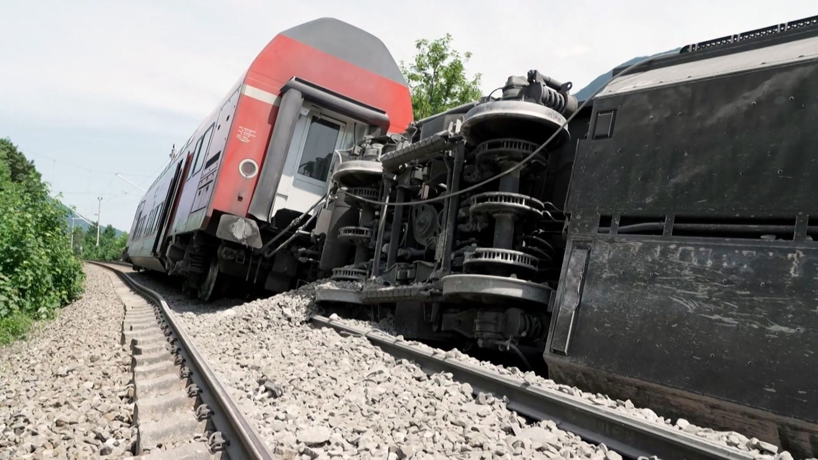 This video grab taken from footage of Network Pictures on June 3, 2022 shows a derailed train near Burgrain near Garmisch-Partenkirchen, southern Germany. - At least three people were killed and several others injured as a train derailed near a Bavarian Alpine resort in southern Germany on June 3, police said. 