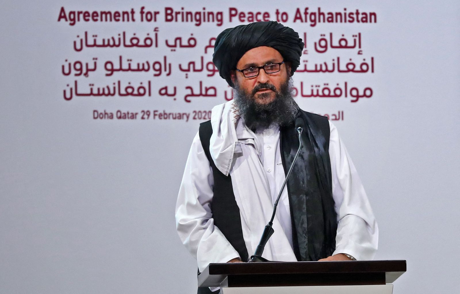 (FILES) In this file photo taken on February 29, 2020 Taliban co-founder Mullah Abdul Ghani Baradar speaks at a signing ceremony of the US-Taliban agreement in Qatar's capital Doha. - Taliban co-founder Mullah Abdul Ghani Baradar arrived in Kabul on August 21, 2021 for talks on establishing a new 