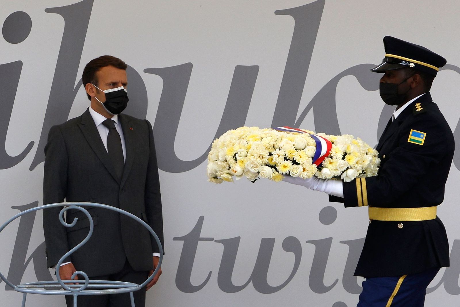 French President Emmanuel Macron readies to lay a wreath in front of  'Kwibuka 27' or �remember-unite-renew� which marks the 27th anniversary of the start of the 1994 genocide against the Tutsi in Rwanda, during visit to the Kigali Genocide Memorial, where some 250,000 victims of the massacres are buried, in Kigali on May 27, 2021. - French President Emmanuel Macron arrived in Rwanda on May 27, 2021, for a highly symbolic visit aimed at moving on from three decades of diplomatic tensions over France's role in the 1994 genocide in the country. Macron is the first French leader since 2010 to visit the East African nation, which has long accused France of complicity in the killing of some 800,000 mostly Tutsi Rwandans. (Photo by Ludovic MARIN / AFP) - AFP