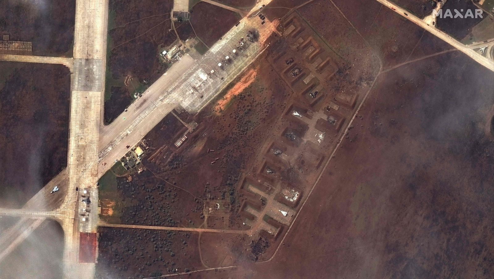 This handout satellite image courtesy of Maxar Technologies released on August 11, 2022 shows the aftermath of the reported attack on the Saki airbase at Novofedorivka, Crimea. - Moscow insisted that major blasts at a key military airbase on the Russian-annexed Crimea peninsula were caused by exploding ammunition rather than Ukrainian fire. (Photo by Satellite image �2022 Maxar Technologies / AFP) / RESTRICTED TO EDITORIAL USE - MANDATORY CREDIT 