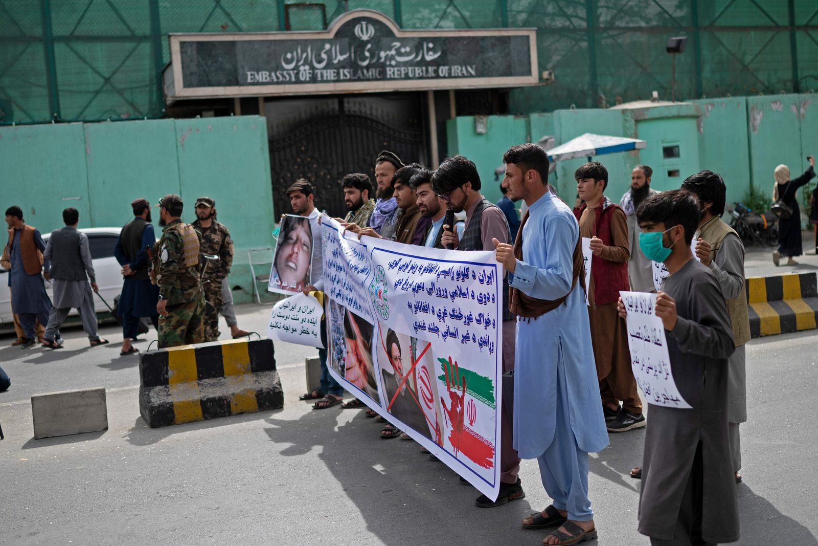 Afghan protestors take part in a protest against the alleged published reports of harassment of Afghan refugees in Iran, in front of the Iranian embassy in Kabul on April 11, 2022. (Photo by Wakil KOHSAR / AFP) - AFP