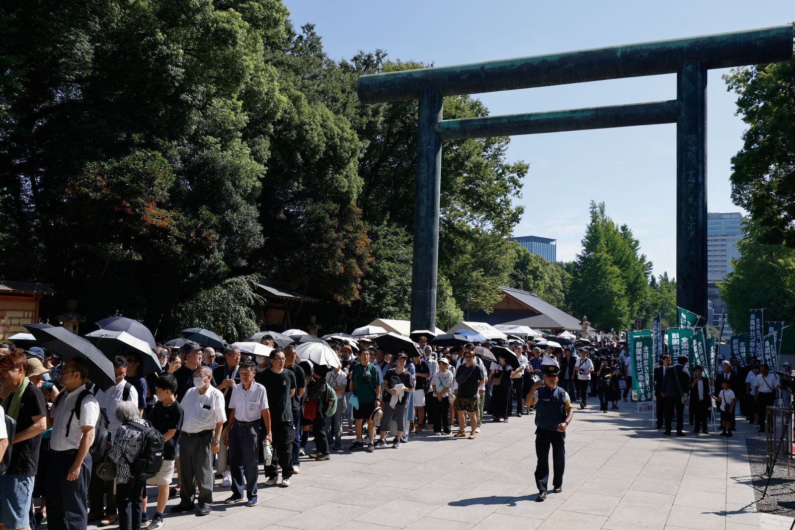 People stand in line to pray during their visit to the Yasukuni Shrine on the 80th anniversary of Japan's surrender in World War Two, in Tokyo, Japan, August 15, 2025. REUTERS/Manami Yamada