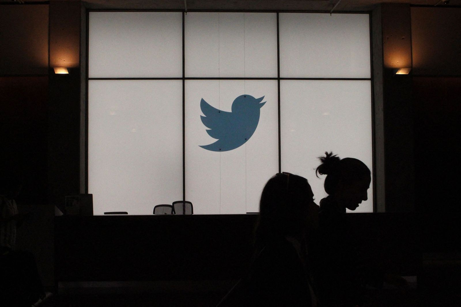 (FILES) In this file photo taken on August 13, 2019, employees walk past a lighted Twitter log as they leave the company's headquarters in San Francisco. - Twitter misled users and federal regulators about glaring weaknesses in its ability to protect personal data, the platform's former security chief claimed in whistleblower testimony likely to impact the company's bitter legal battle over Elon Musk's takeover bid. In a complaint filed with the US Securities and Exchange Commission and published in part August 23, 2022, by The Washington Post and CNN, Peiter Zatko also accused Twitter of significantly underestimating the number of automated bots on the platform -- a key element in Musk's argument for withdrawing his $44 billion buyout deal. (Photo by Glenn CHAPMAN / AFP) - AFP