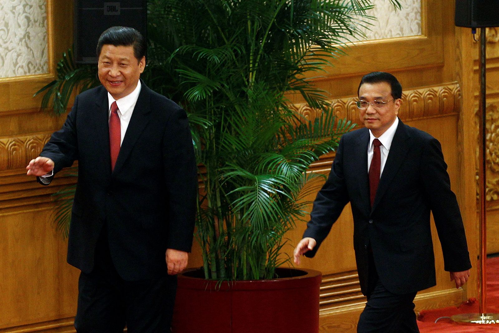 FILE PHOTO: China's new Politburo Standing Committee members Xi Jinping and Li Keqiang arrive to meet with the press in Beijing - REUTERS