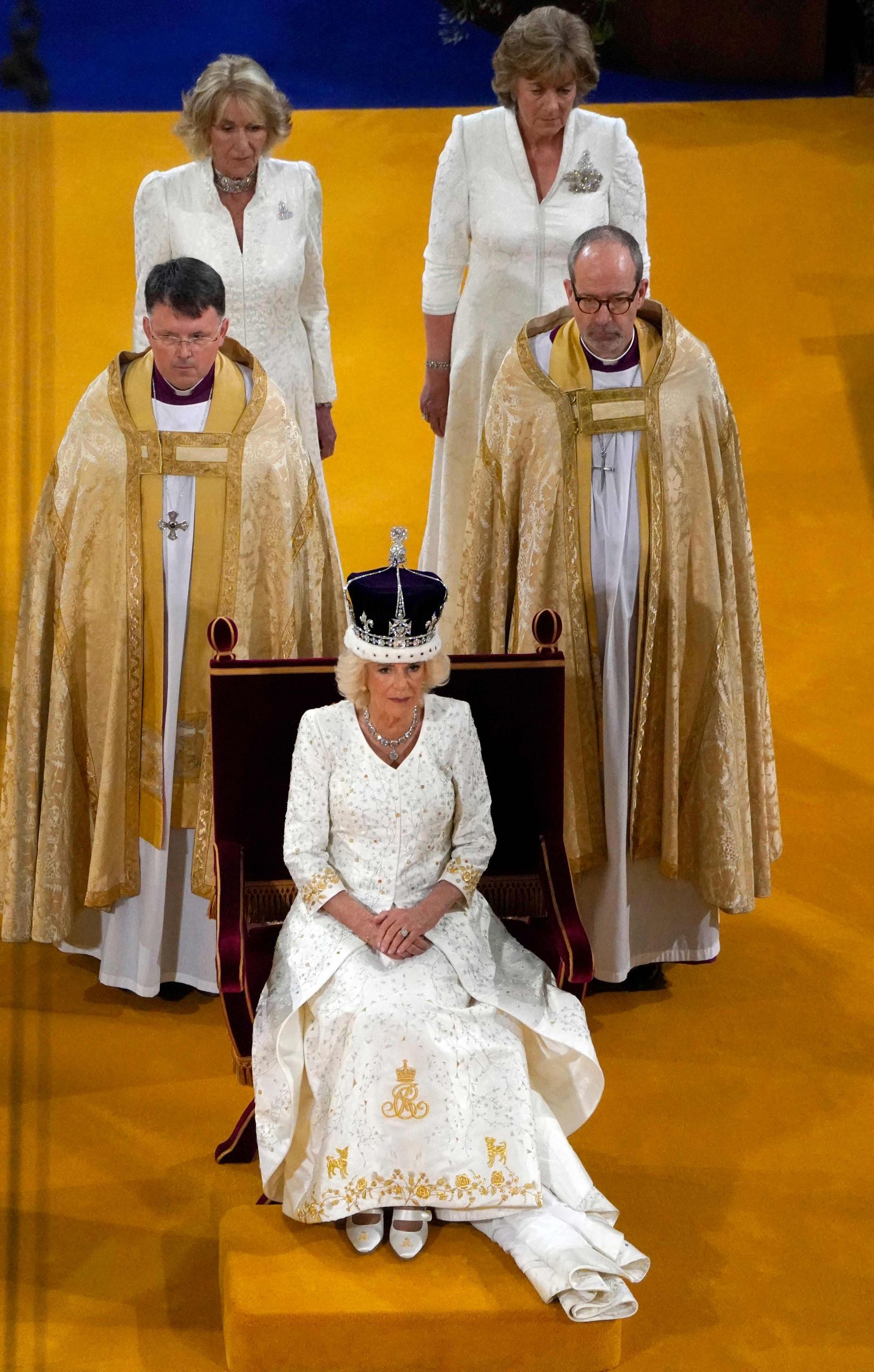 Britain's Camilla sits on the throne wearing a modified version of Queen Mary's Crown during the Coronation Ceremony inside Westminster Abbey in central London, on May 6, 2023. - The set-piece coronation is the first in Britain in 70 years, and only the second in history to be televised. Charles will be the 40th reigning monarch to be crowned at the central London church since King William I in 1066. Outside the UK, he is also king of 14 other Commonwealth countries, including Australia, Canada and New Zealand. (Photo by Andrew Matthews / POOL / AFP) - AFP