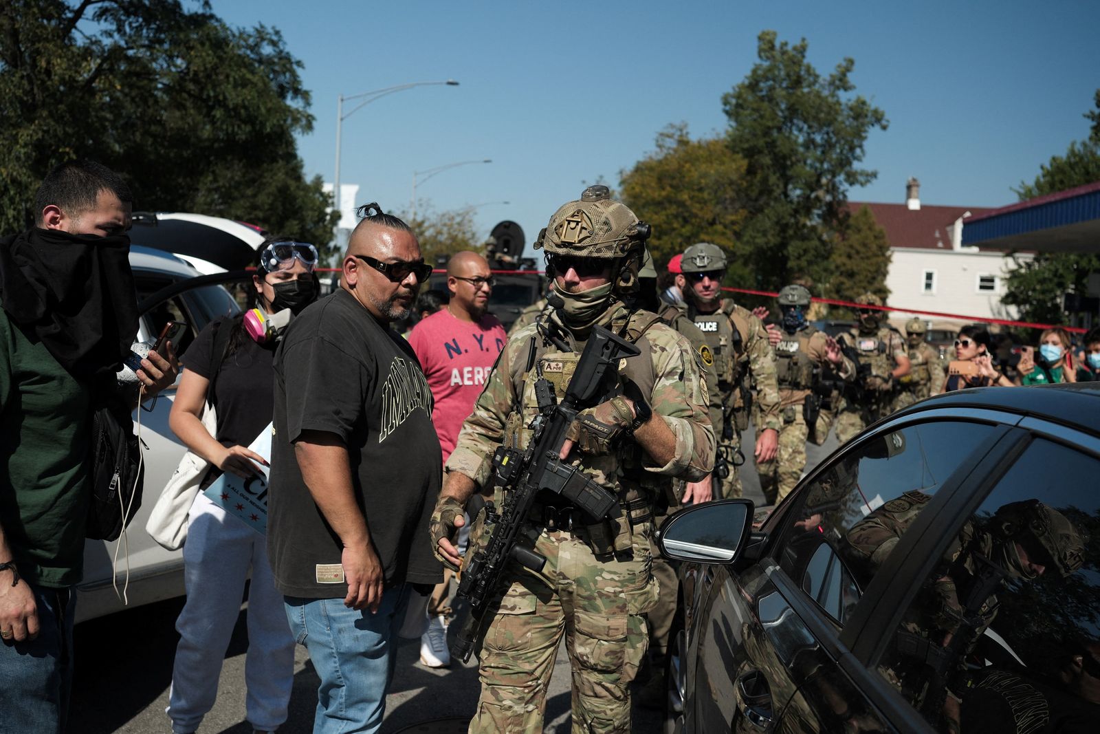 Law enforcement officers walk next to demonstrators during a standoff with U.S. Immigration and Customs Enforcement (ICE) and federal officers in the Little Village neighborhood of Chicago, Illinois, U.S., October 4, 2025. REUTERS/Jim Vondruska