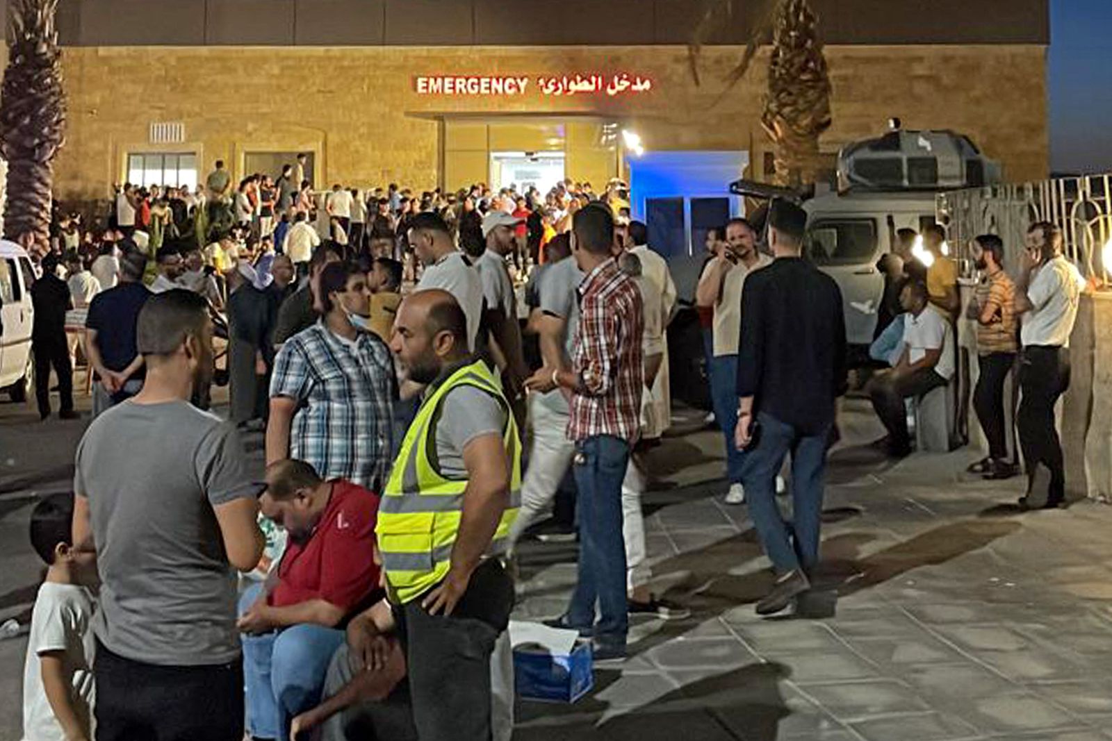 People gather outside a hospital following a toxic gas explosion in Jordan's Aqaba port, on June 27, 2022. - Footage on state-owned Al-Mamlaka TV showed the large cylinder, said to have been carrying about 30 tonnes of gas, plunging from a crane on a moored vessel, causing a violent release of the gas cloud. (Photo by AFP) - AFP