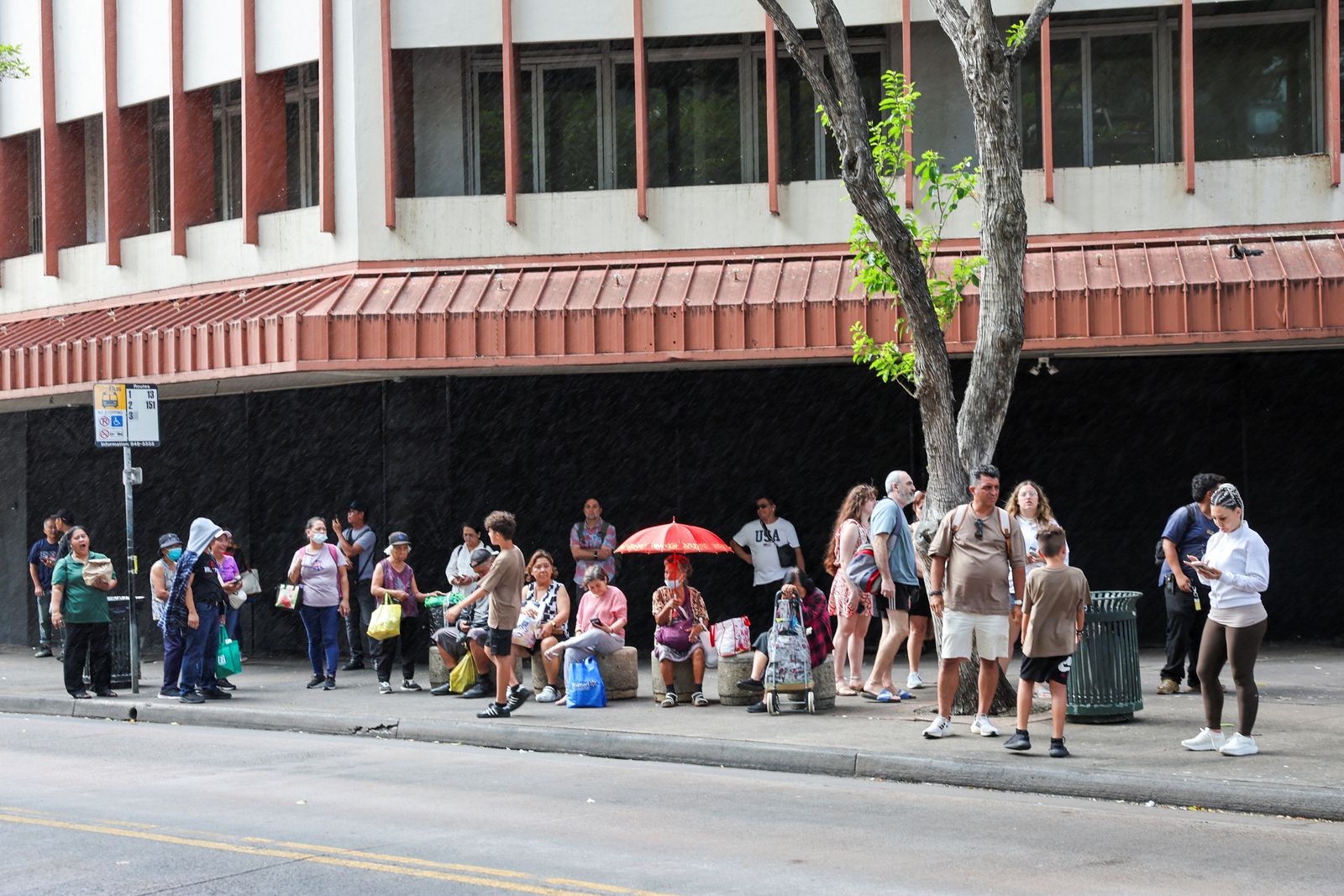 With traffic jams across Oahu, bus riders wait for their buses after authorities warned residents of the possibility of destructive tsunami waves, following an earthquake which earlier struck off Russia's Far Eastern Kamchatka Peninsula, in Honolulu, Hawaii, U.S. July 29, 2025.    REUTERS/Marco Garcia