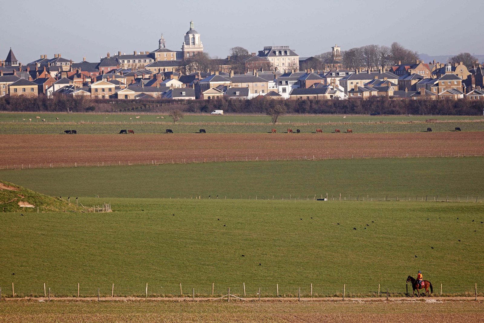 A photograph taken on February 7, 2023 shows a general view of Poundbury and the surrounding fields. - Poundbury is an experimental planned community or urban extension on the western outskirts of Dorchester in the county of Dorset, southern England made by Britain's King Charles III. Poundbury was developed on land belonging to the Duchy of Cornwall, a royal estate run under the stewardship of the Prince of Wales. (Photo by Adrian DENNIS / AFP) - AFP