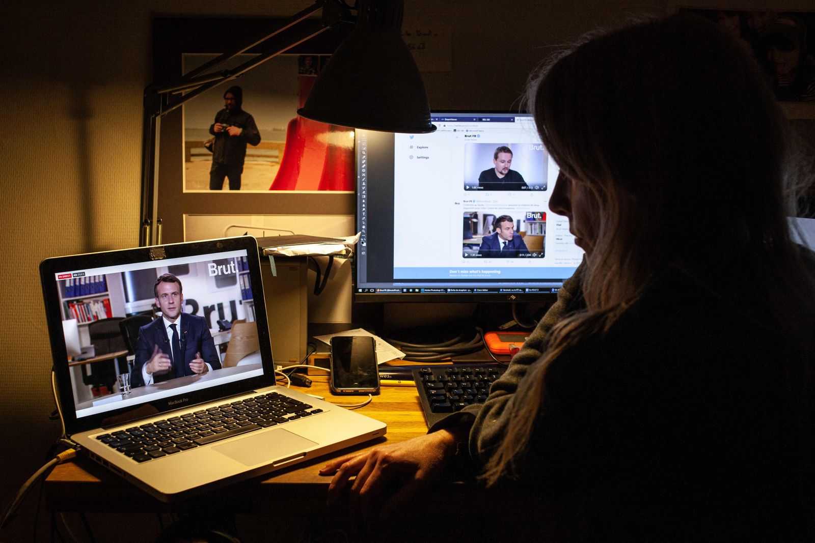 A woman watches a live stream interview of French President Emmanuel Macron to the digital news platform Brut on December 4, 2020 in Le Raincy, on the outskirts of Paris. (Photo by Guillaume BAPTISTE / AFP) - AFP