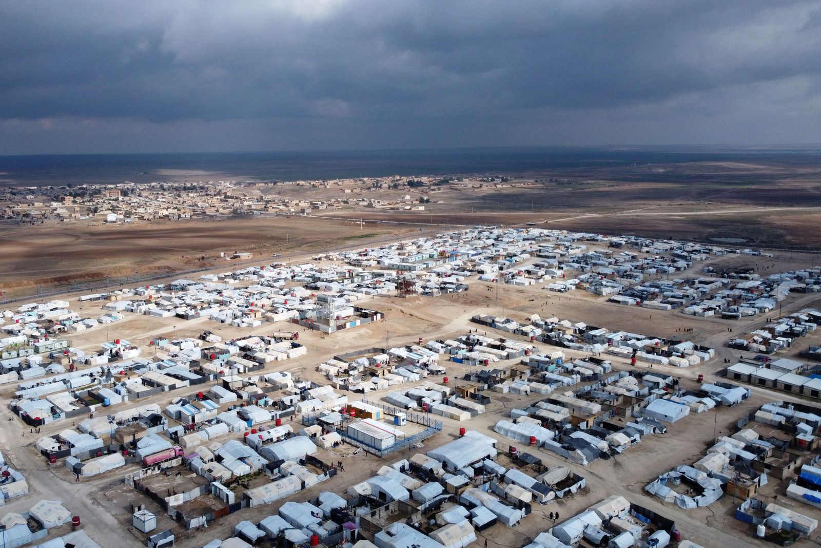 This aerial picture taken on January 27, 2024 shows a view of al-Hol camp in Syria's northeastern Al-Hasakah Governorate. The al-Hol camp is the largest of two in northeastern Syria holding the families of Islamic State fighters. Run by US-backed Kurdish-led Syrian Democratic Forces (SDF), its population spiked at more than 70,000 as the coalition began tightening its grip on the last IS holdout in Baghouz late in 2018. (Photo by Delil SOULEIMAN / AFP)