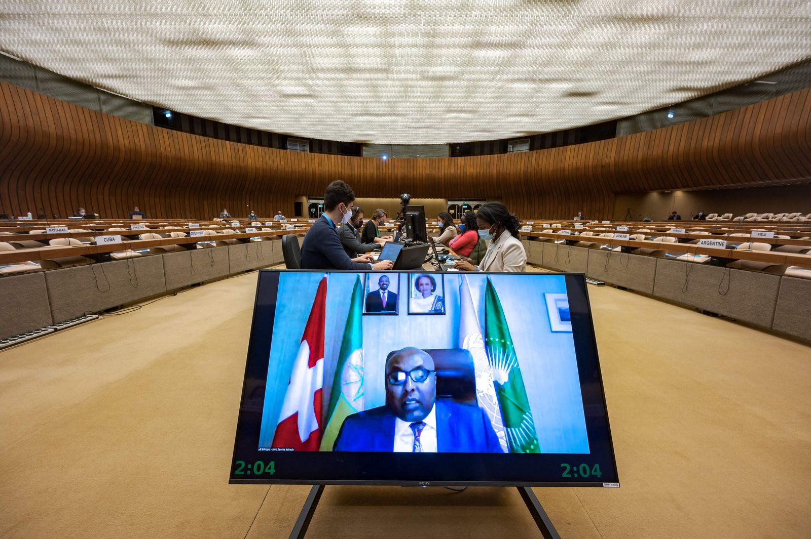 Ambassador and Permanent Representative of Ethiopia to the UN Zenebe Kebede (on screen) delivers a speech remotely during an extraordinary meeting on Ethiopia at the United Nations (UN) Human Rights Council in Geneva on December 17, 2021. - The United Nations warned that all sides in Ethiopia's 13-month conflict were committing severe abuses, and cautioned that generalised violence could ensue, with implications for the entire region. (Photo by Fabrice COFFRINI / AFP) - AFP