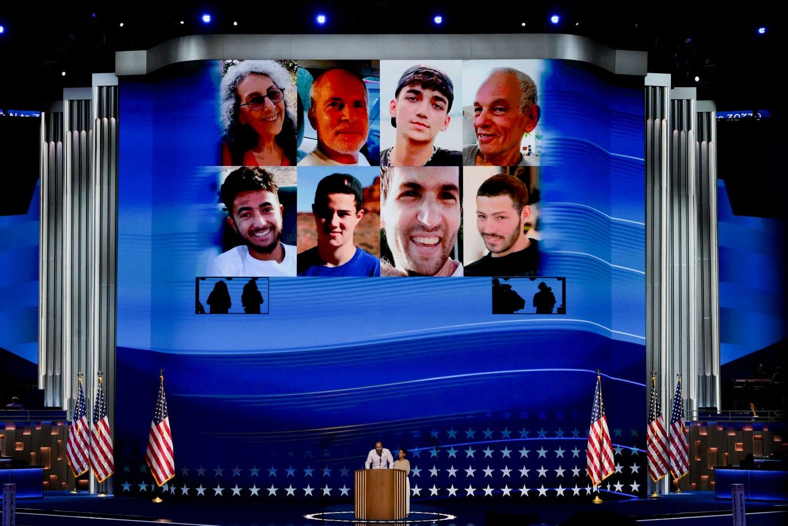 Jon Polin and Rachel Goldberg, parents of Hersh Goldberg-Polin, who is being held hostage in Gaza, bottom center, speak during the Democratic National Convention (DNC) at the United Center in Chicago, Illinois, US, on Wednesday, Aug. 21, 2024. The Democratic National Convention this week marks the ceremonial crowning of Vice President Kamala Harris and Minnesota Governor Tim Walz as the party's presidential nominees, capping off a whirlwind month for Democrats who quickly coalesced behind the new ticket after President Joe Biden dropped out of the race in July. Photographer: David Paul Morris/Bloomberg