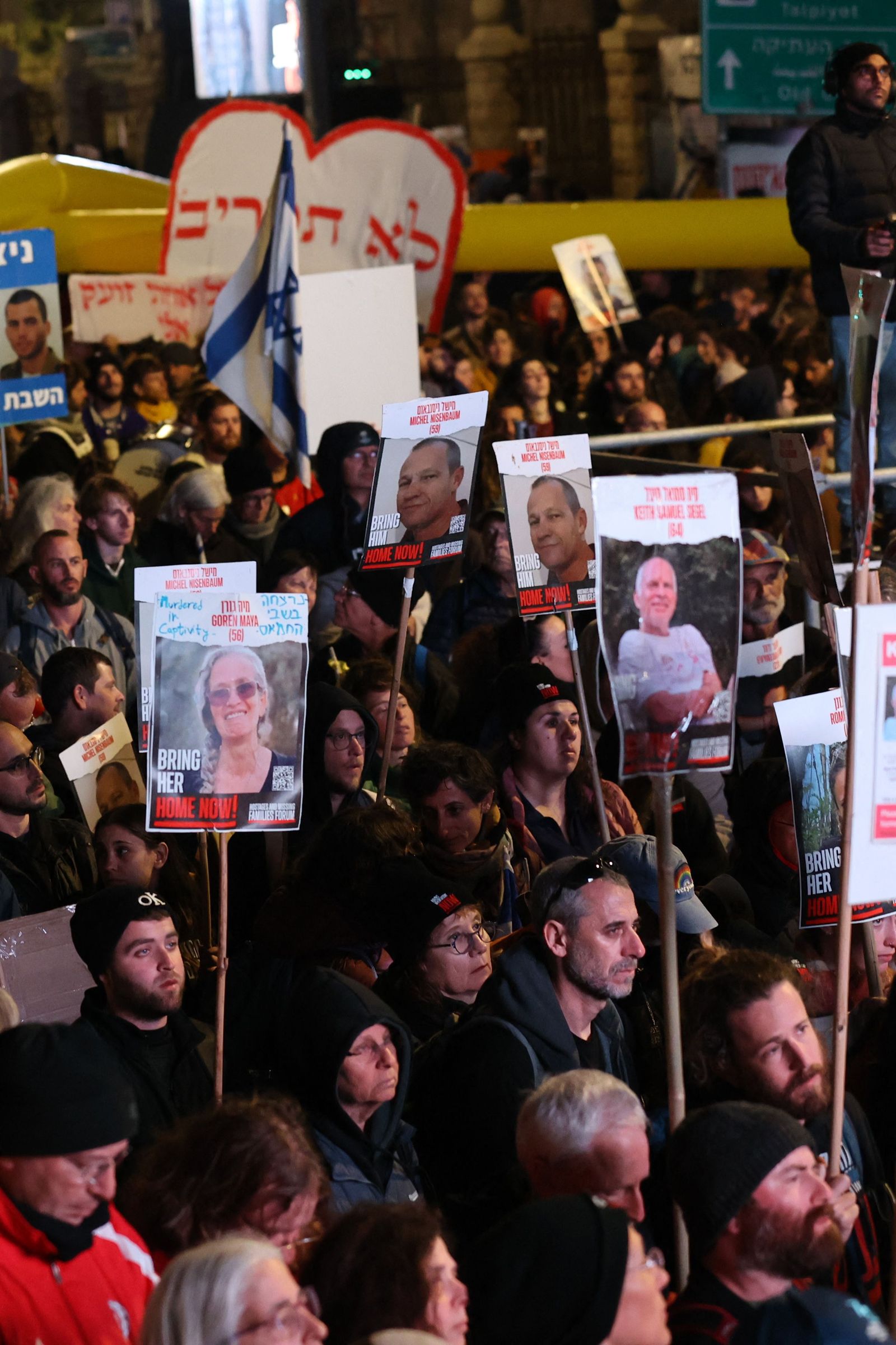 Demonstrators holding portraits of Israeli hostages protest in front of the prime minister's residence in Jerusalem on March 2, 2024 to pressure the government to secure the release of hostages held by the Palestinian Hamas movement in the Gaza Strip since the October 7, 2023 attacks. The protesters reached Jerusalem in the evening, capping a four-day march from the Gaza border to call for the release of the 130 remaining hostages in captivity according to Israel, a figure including 31 presumed dead. (Photo by GIL COHEN-MAGEN / AFP)