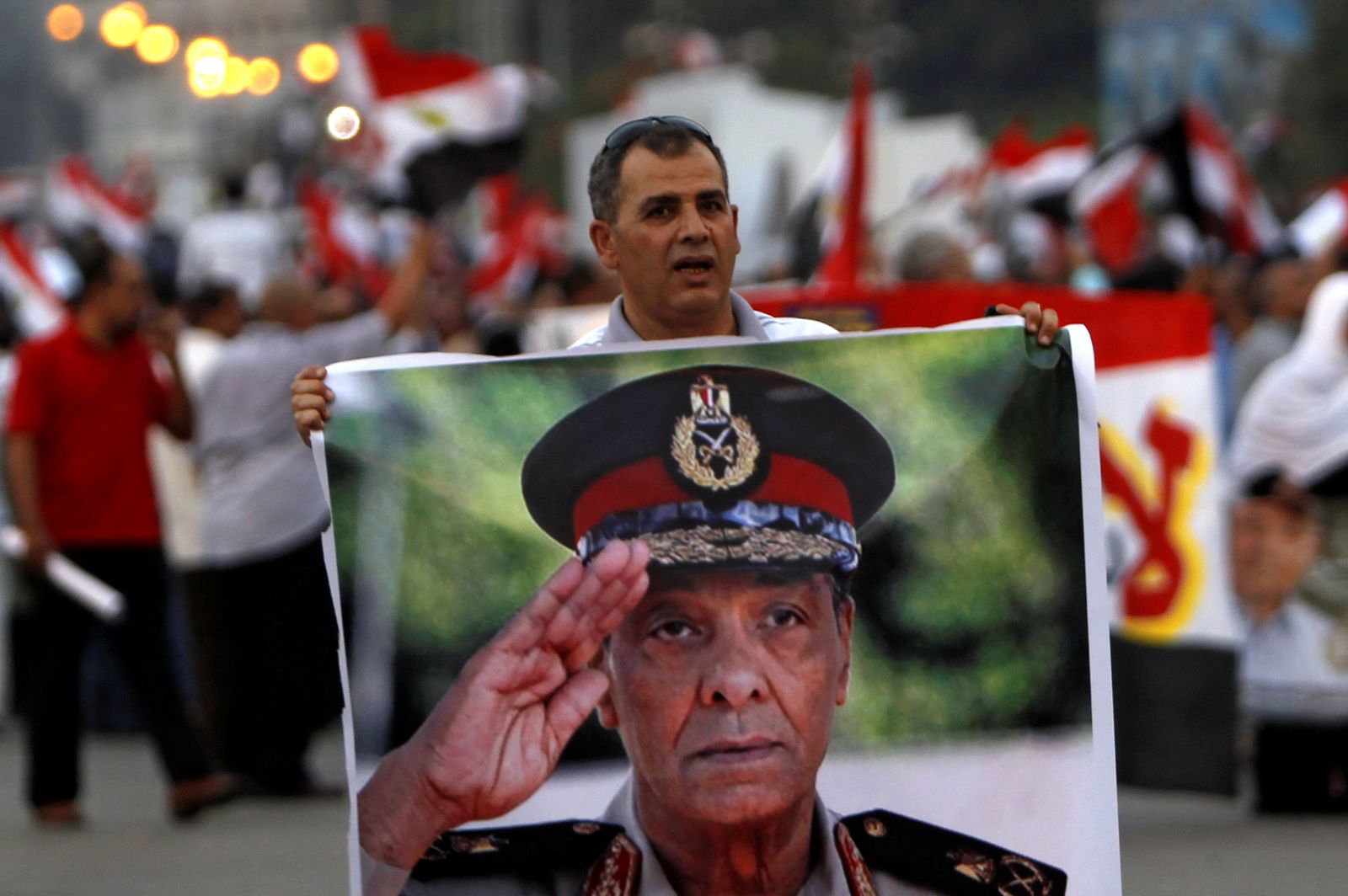 FILE PHOTO: A supporter of former prime minister and current presidential candidate Ahmed Shafik holds a poster of Field Marshal Mohamed Hussein Tantawi - REUTERS