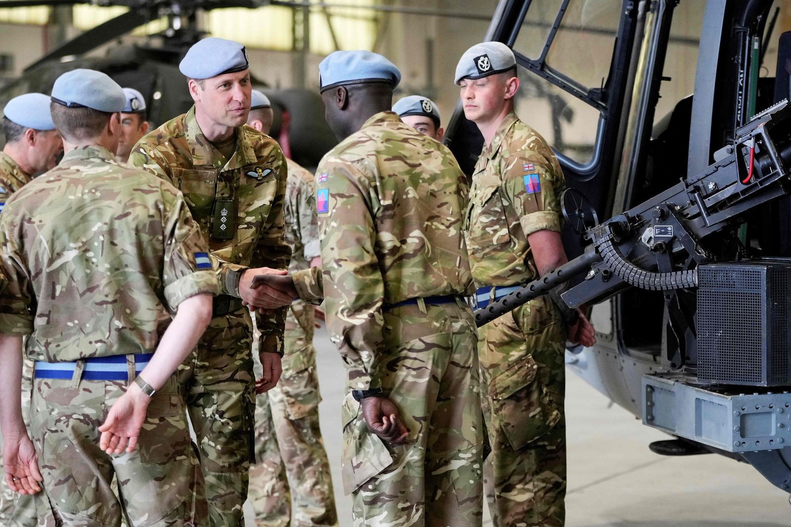 Britain's Prince William, Prince of Wales (C) speaks to service personal at the Army Aviation Centre in Middle Wallop, England, Monday, May 13, 2024. Britain's King Charles III officially handed over the role of Colonel-in-Chief of the Army Air Corps to his son Britain's Prince William, Prince of Wales. (Photo by Kin Cheung / POOL / AFP)