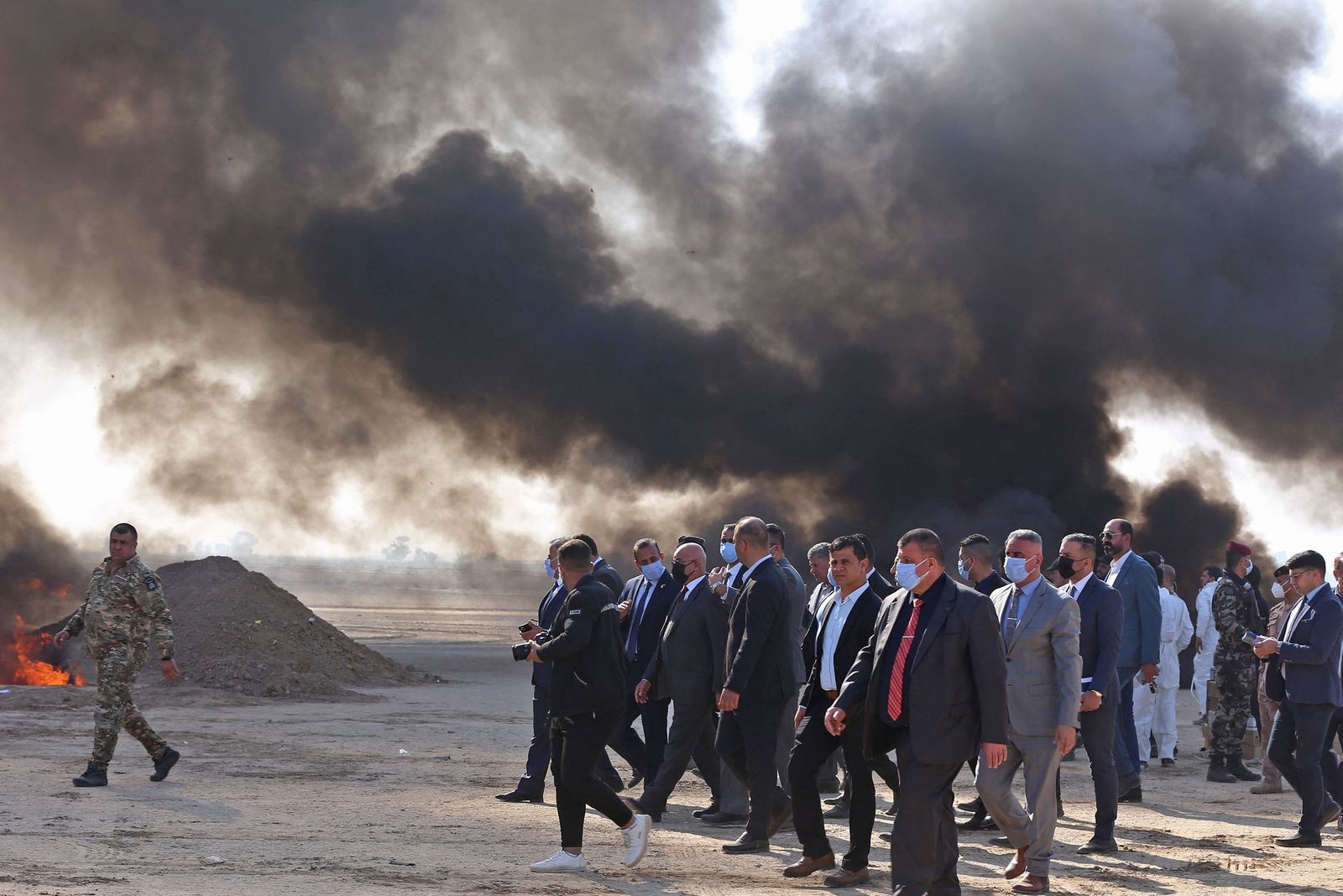 Iraqi government officials destroy nearly six tons of drugs, some of which had been in storage for more than a decade, in Baghdad's Nahrawan area on December 18, 2022. - Speaking in front of assembled media who were invited to cover the destruction near a military base outside Baghdad, he said it was the first 